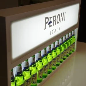 A custom Peroni illuminated back bar bottle display featuring some peroni bottles.