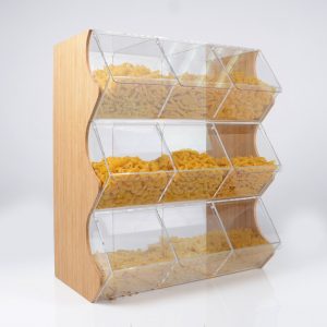 A clear acrylic food dispenser with 9 compartments, bamboo side panels and different pastas in the compartments.