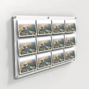 A clear and white wall mounted 12 pocket postcard holder with postcards on display.