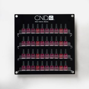 A wall mounted Branded Nail Polish Display with nail vanishes on display.
