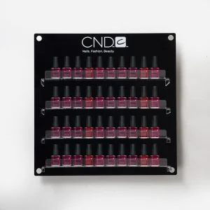 A wall mounted Branded Nail Polish Display with nail vanishes on display.