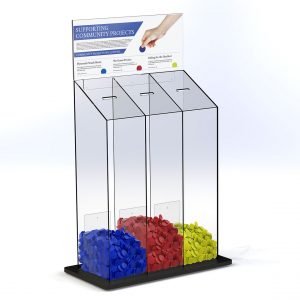 A charity token collection box with a header, three sections and red, blue and yellow tokens.