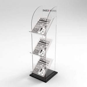 A three tier clear acrylic newspaper stand with newspapers on display, a black base and branding.