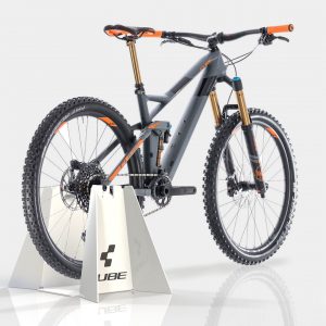 A white acrylic, custom branded bike stand with a bike on display.