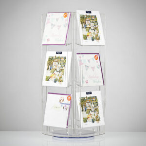 A rotating countertop greeting card spinner with greeting cards on display.
