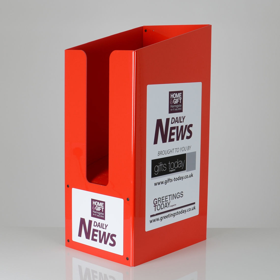 A red made to measure dump bin with "home and gate Harrogate" custom branding on the front and sides.