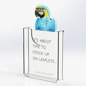An angled custom leaflet dispenser with a parrot header and a message on the back panel reading "It's about time to stock up on leaflets".