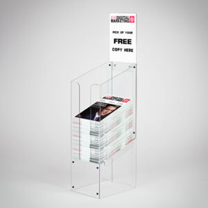 A clear acrylic dump bin with a header holding magazines.