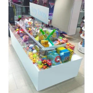 A white product merchandiser island with a selection of different toys inside.