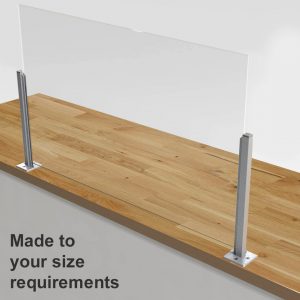 A made to measure sneeze screen on a wooden countertop.