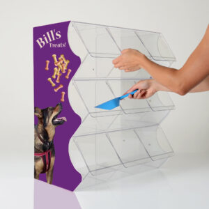 A clear acrylic pick and mix display unit with 9 compartments, a custom printed side panel of dog treats and a dog and a hand reaching in holding a blue scoop.