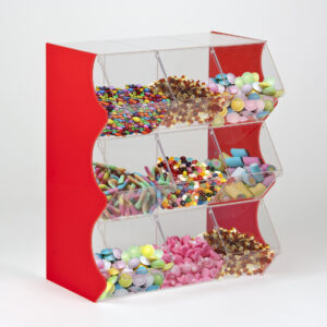 A red 9 container stacked pick and mix dispenser full of different unwrapped sweets.