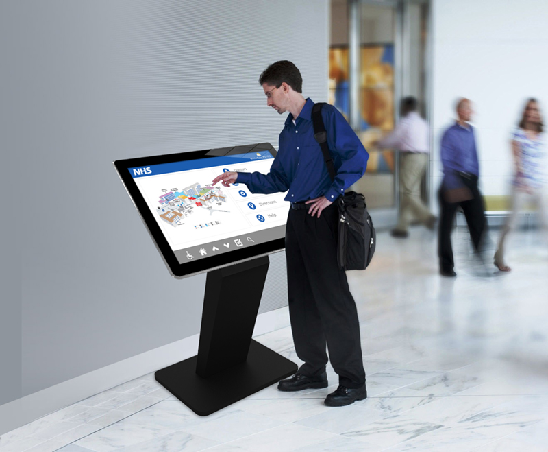 A windows touch screen kiosk being used by a person.