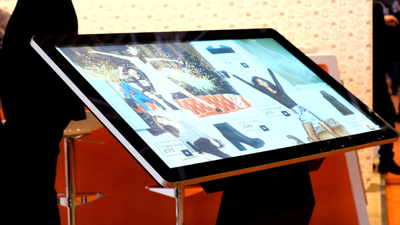 A windows touch screen kiosk with a silver bezel.