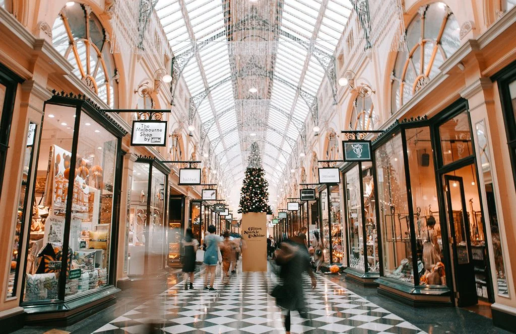 person-walking-inside-glass-building-market-retail-heidi-fin-unsplash