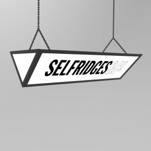 An illuminated ceiling hanging lightbox with selfridges&co" custom logo.
