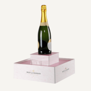 A bespoke pink counter display plinth with a bottle of champagne on top.