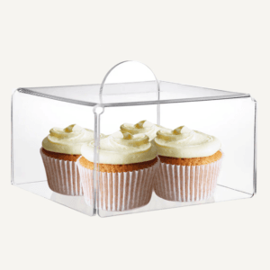 A clear acrylic food cover covering 4 cupcakes.