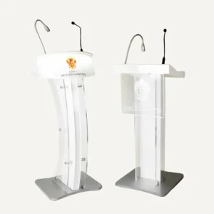 Two acrylic lecterns with silver and black microphones and logos on the front of them.