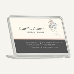 A mini business card holder with a logo and business contact details written on it.