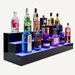 A three tiered illuminated display plinth with different alcoholic spirits sat on top.