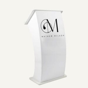 White curved acrylic lectern with "M, Mathew Wilson" logo on the front.