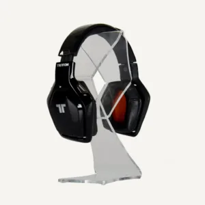 A clear acrylic headphone stand with headphones on display.