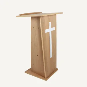 A wooden church lectern facing the right with a large white cross on the front.