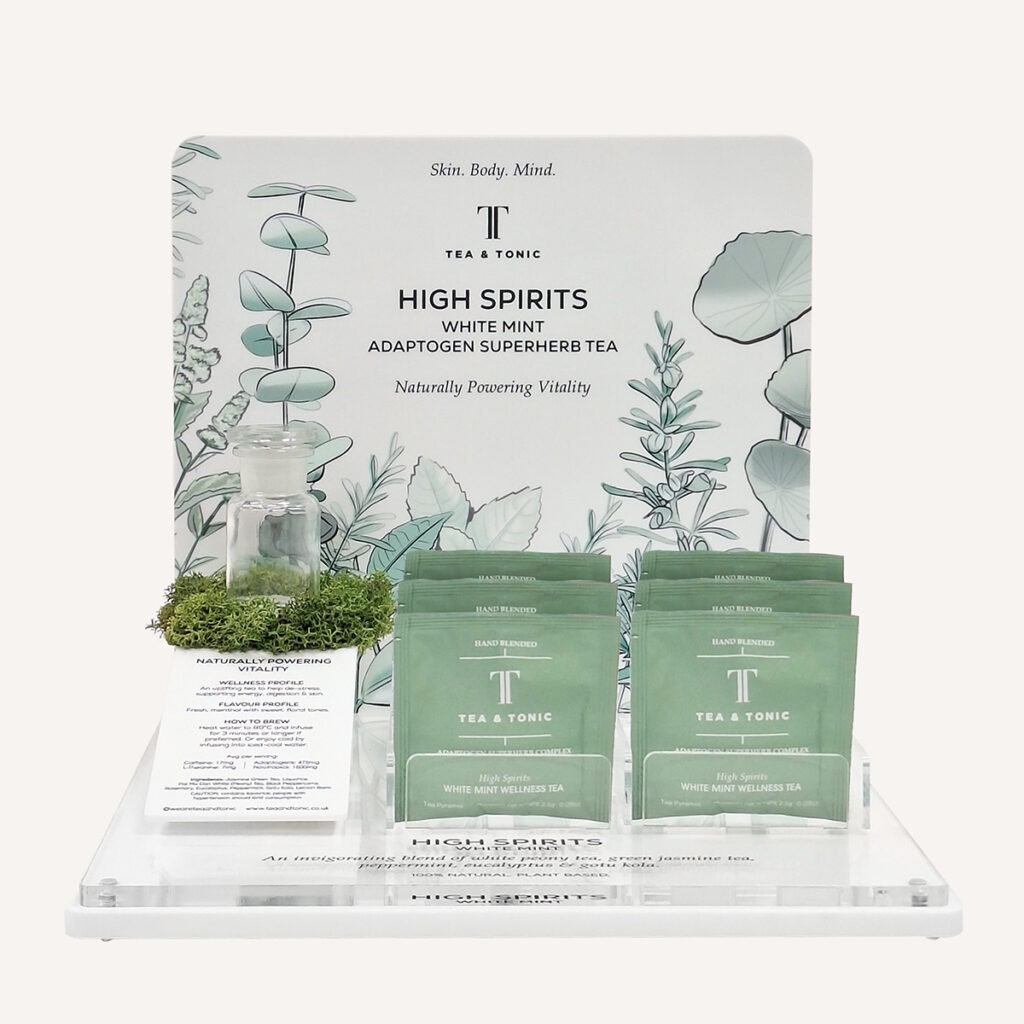 Tea & Tonic countertop product dispenser and glorifier in pale green with decorative moss and custom branding.