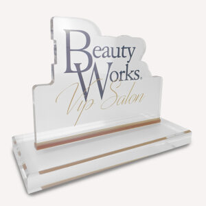 A solid clear acrylic, custom made award with "beauty works" logo on the front.