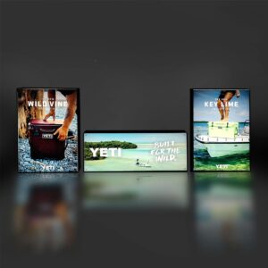 Floor standing Illuminated lightboxes in a dark room with yeti branding.