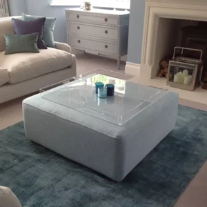 Clear Acrylic Tray on grey material coffee table or ottoman with candles on display.