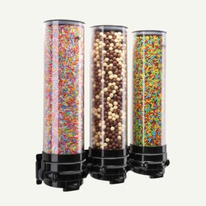A three cylinder, wall mounted candy dispenser with different chocolate and sweet toppings inside.