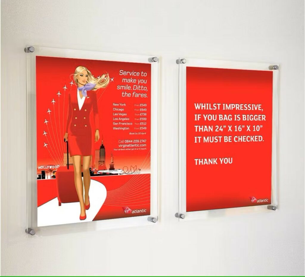 A virgin atlantic advertisement in two clear acrylic frames.