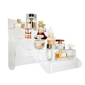 A clear acrylic countertop display with multiple tiered shelves holding different perfumes.