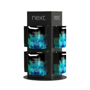 A custom"next" rotating countertop display holding gift cards.