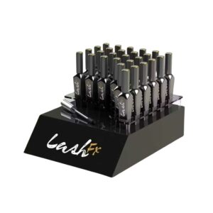 A countertop display holding mascara bottles.