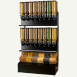 A floor standing bulk dry food dispenser with different dry foods inside.