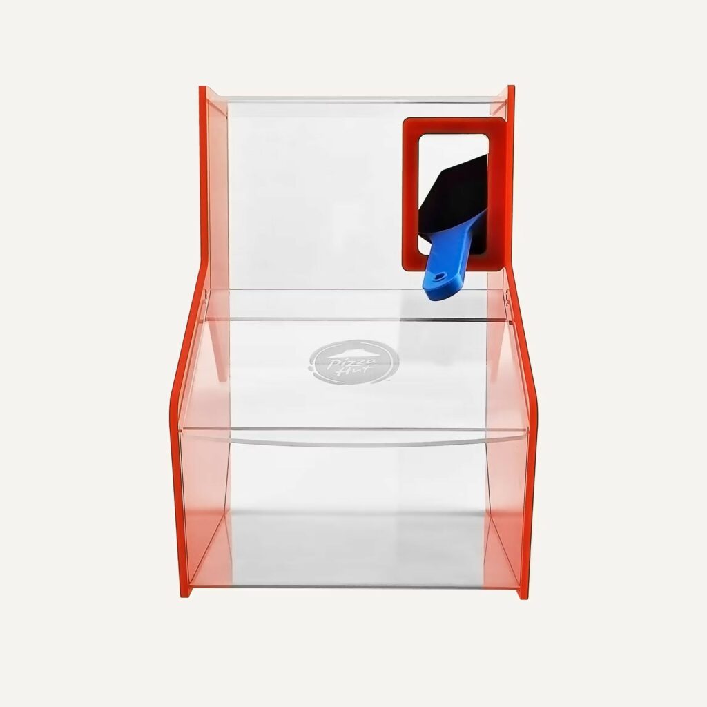 A custom pizza hut countertop pick and mix bin with scoop.