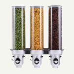 A set of three wall mounted dry food dispenser with different dried foods inside.