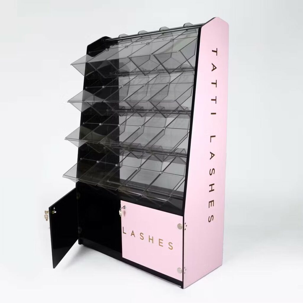 A custom made tatti lashes pick and mix display with a bottom cupboard door swung open.