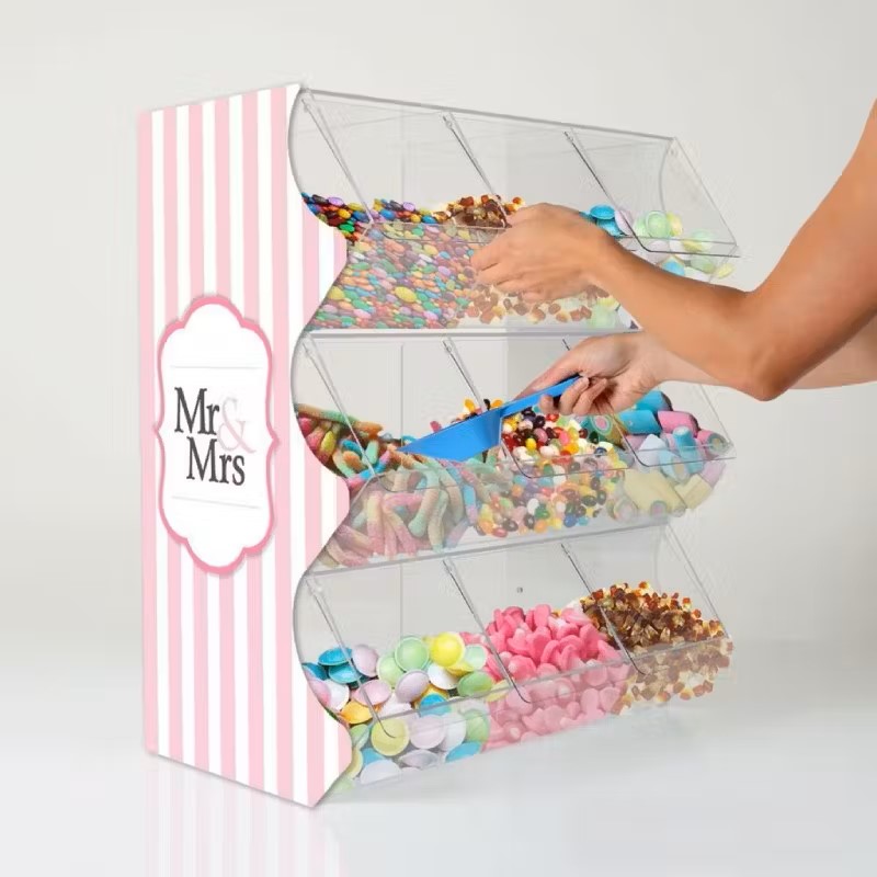 A hand reaching in to get sweets from a custom wedding pick and mix dispenser.