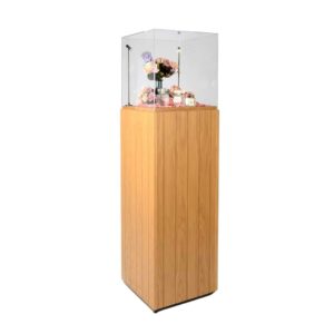 A wooden and clear acrylic display plinth with lighting and products on display.