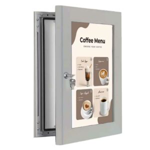 A lockable poster board frame that is half open with keys.