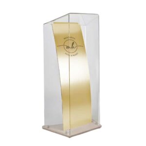 A clear acrylic and gold lectern.