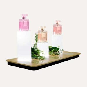 Illuminated countertop plinths with products sat on top.