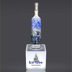 An illuminated countertop bottle plinth with vodka sat on top.