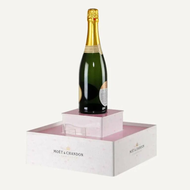 A portable pink, custom plinth with a bottle on top.